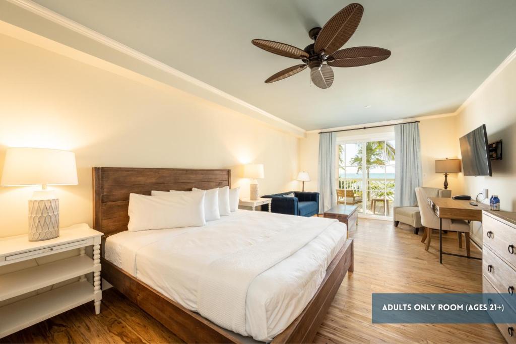 a bedroom with a bed and a ceiling fan at Grassy Flats Resort & Beach Club in Marathon