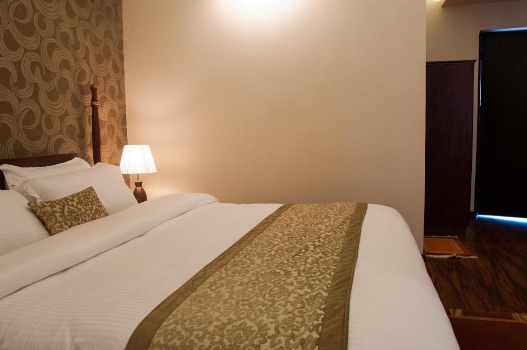Postel nebo postele na pokoji v ubytování Mandala Boutique Hotel