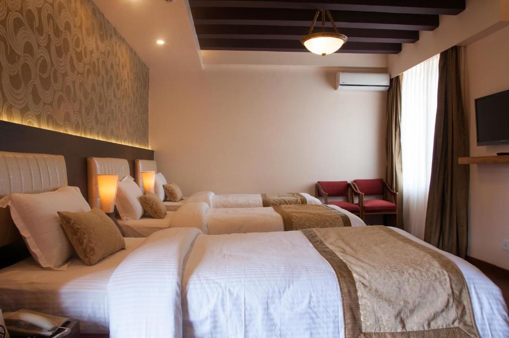 Postel nebo postele na pokoji v ubytování Mandala Boutique Hotel