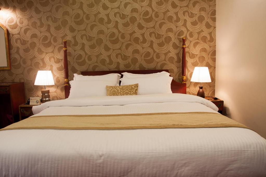 Postel nebo postele na pokoji v ubytování Mandala Boutique Hotel