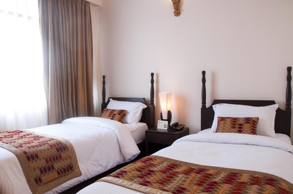 Postel nebo postele na pokoji v ubytování Mandala Boutique Hotel