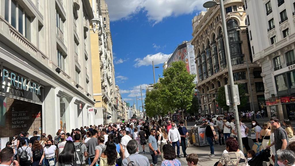 a crowd of people walking down a busy city street at DELUXE APARTMENT NEAR GRAN VIA in Madrid