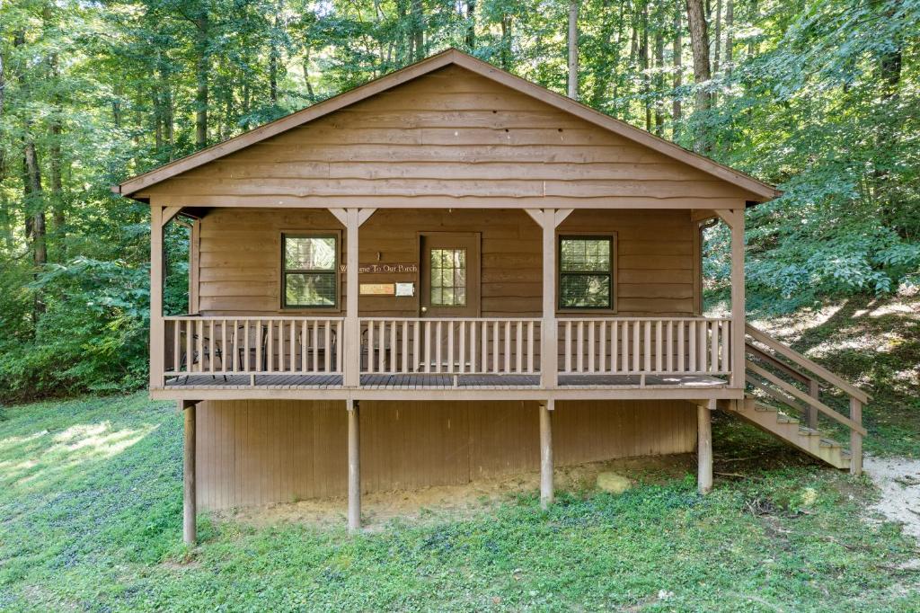 a large wooden cabin in the middle of a forest at Wilstem Cabins in French Lick