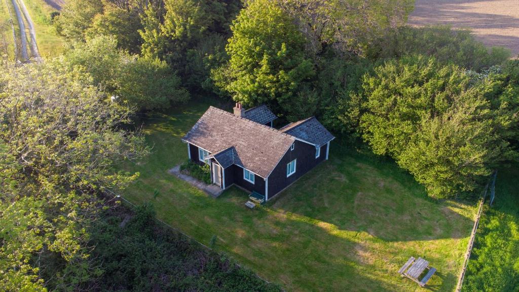 an aerial view of a black house in the forest at Henllys Lodge in Velindre-farchog