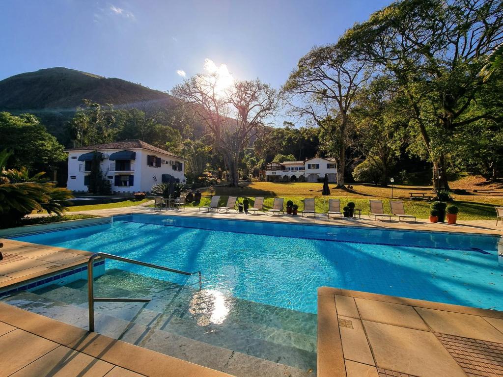 a large swimming pool in front of a house at Saison Resort & Spa in Itaipava