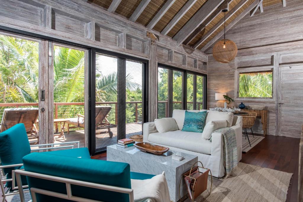 a living room with a couch and chairs at The Hideout in Jost Van Dyke
