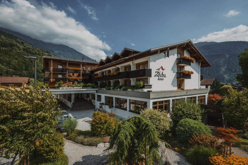 a view of the alpine hotel with mountains in the background at Hotel Zimba in Schruns