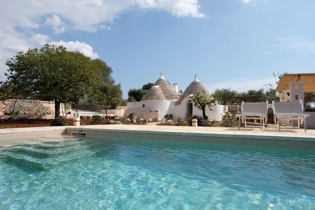 a swimming pool in front of a house at Dimora Iconica in Locorotondo