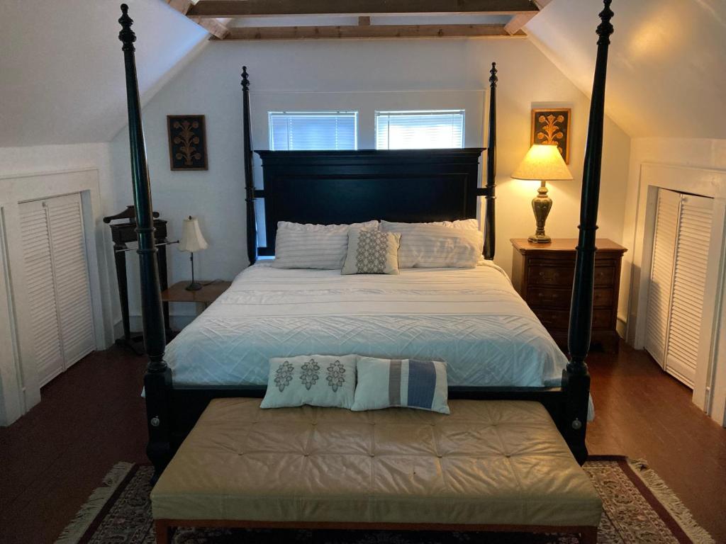 a bedroom with a large bed with a black frame at Country House on 1 Acre 4 Beds Great for Events or a quiet weekend! in Independence