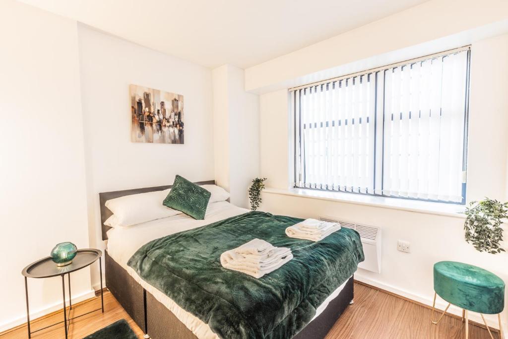 a small bedroom with a bed and a window at City centre apartment in Birmingham