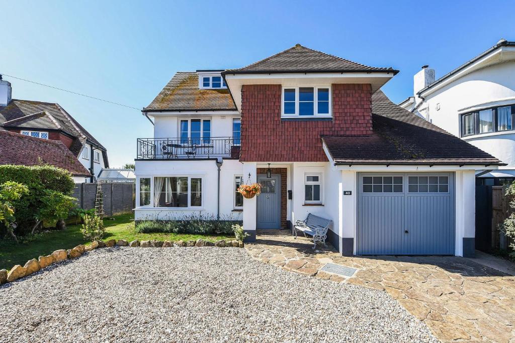 a detached house with a garage and a driveway at Merriesands, Middleton - On - Sea in Middleton-on-Sea