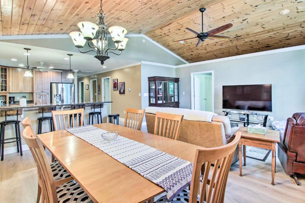 a dining room and living room with a table and chairs at Readfield Retreat with Lake Maranacook Views! in Readfield