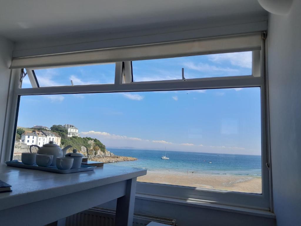 a view of the beach from a window at The Loft at Beach House in St Austell