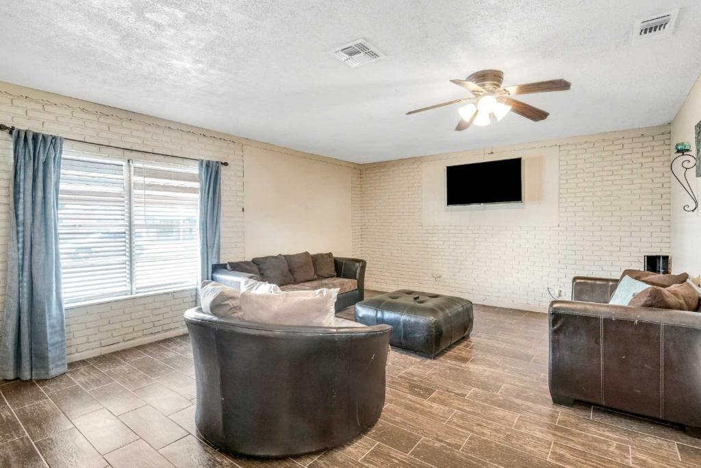 a living room with a couch and a ceiling fan at San Antonio Home with Yard, 7 Mi to SeaWorld! in San Antonio