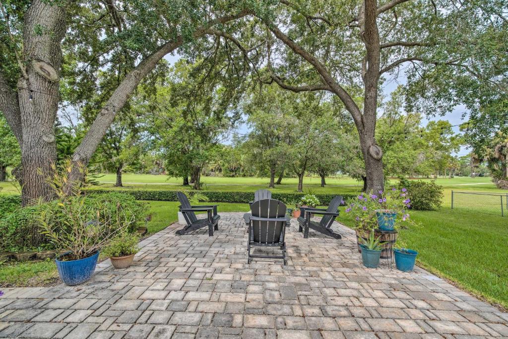 a patio with benches and potted plants in a park at Crystal River Gem Near Three Sisters Springs! in Crystal River