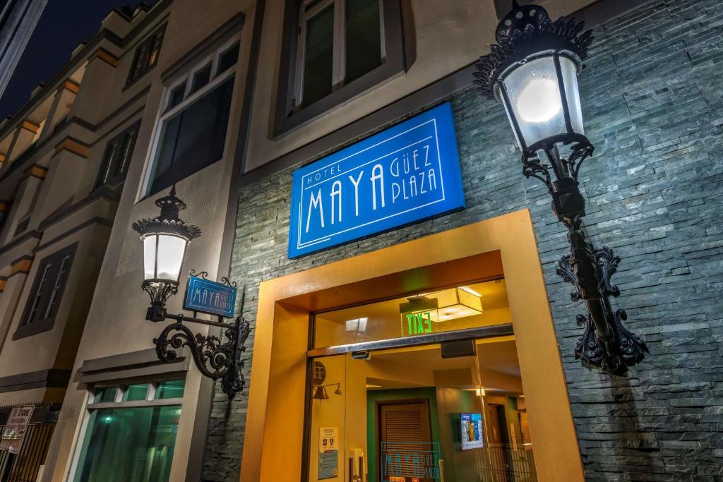 a building with a blue sign on the side of it at Mayaguez Plaza Hotel; SureStay Collection by Best Western in Mayaguez