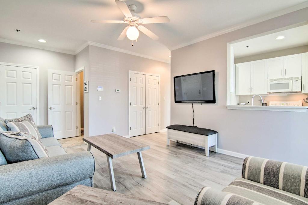 a living room with a couch and a flat screen tv at Rehoboth Beach Condo with Patio 5 Mi to Ocean! in Rehoboth Beach