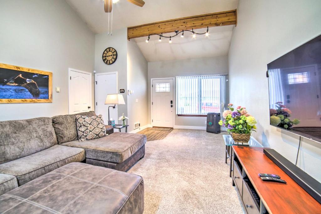 a living room with a couch and a tv at Idaho Falls Townhome about 5 Mi to Tauthaus Park! in Idaho Falls