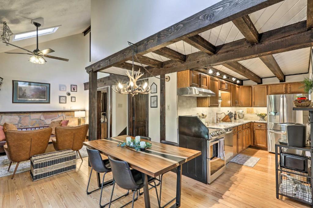 eine Küche und ein Esszimmer mit Tisch und Stühlen in der Unterkunft Woodsy Flagstaff Hideaway with Deck and Sunroom! in Mountainaire