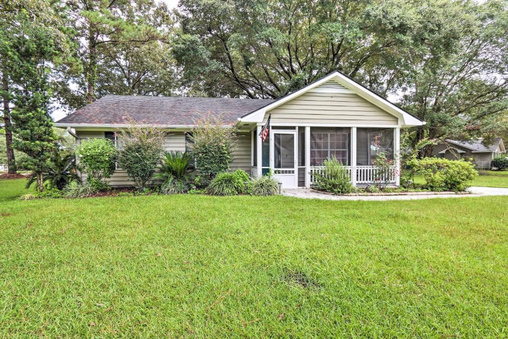 a small house with a lawn in front of it at Peaceful Beaufort Home with Front Porch and Grill in Beaufort