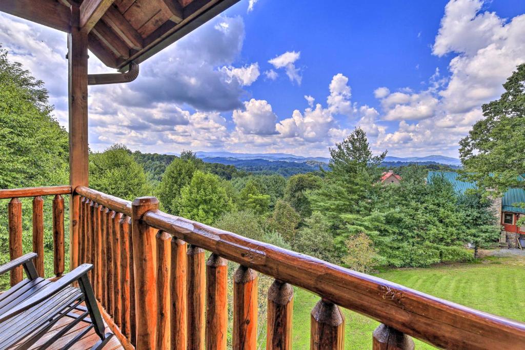 a wooden balcony of a cabin with a bench on it at Gorgeous Piney Creek Cabin with River Access! in Piney Creek
