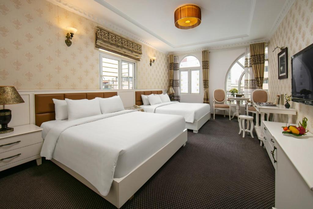 Giường trong phòng chung tại Nesta Boutique Hotel Hanoi