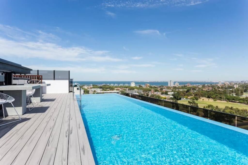 a swimming pool on the roof of a building at Rooftop infinity pool - St Kilda luxury in Melbourne