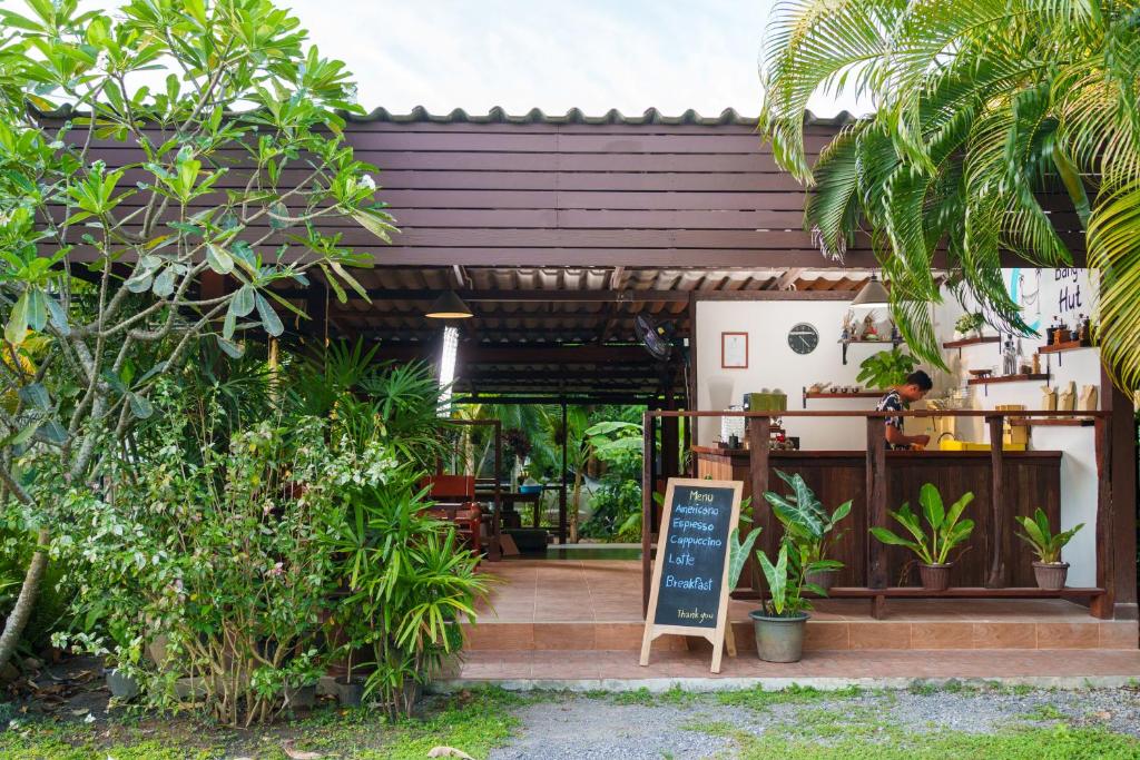 a coffee shop with a sign in front of it at Bang Po Hut in Ban Bang Po