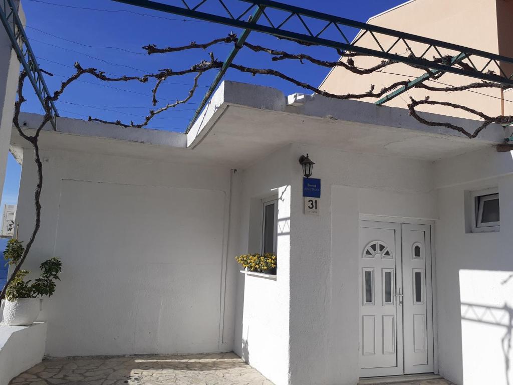 a white house with a white door at Apartments by the sea Brist, Makarska - 19330 in Podaca
