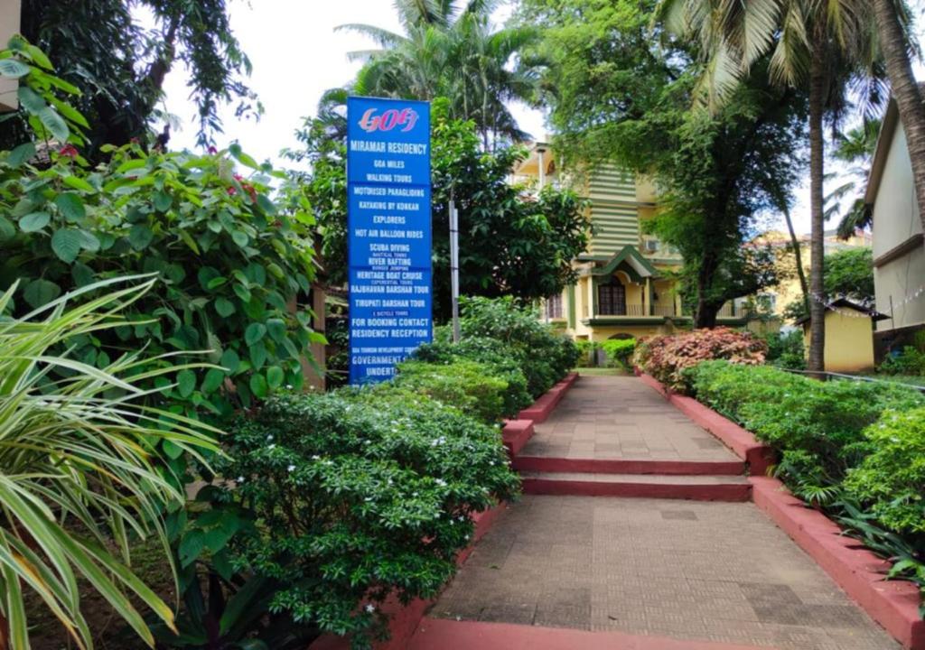 a sign in the middle of a walkway in front of a house at Miramar Residency in Panaji