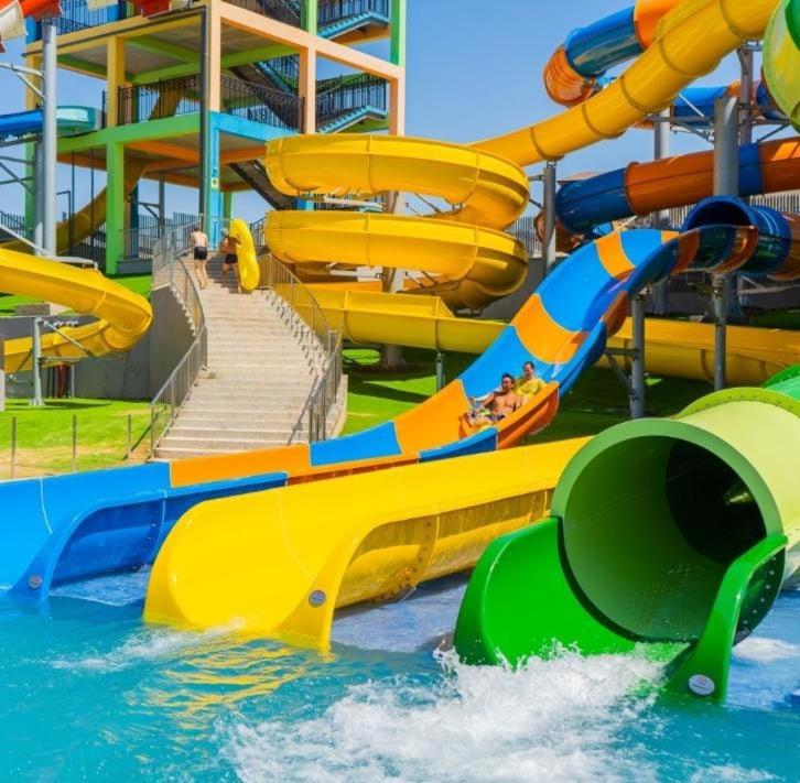 a water slide in a water park with people on it at Квартира у моря in Aktau