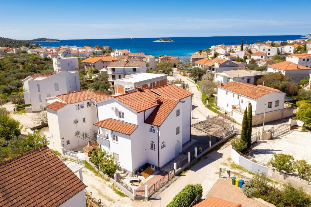 an aerial view of a town with white houses and the ocean at Apartments by the sea Rogoznica - 19367 in Rogoznica