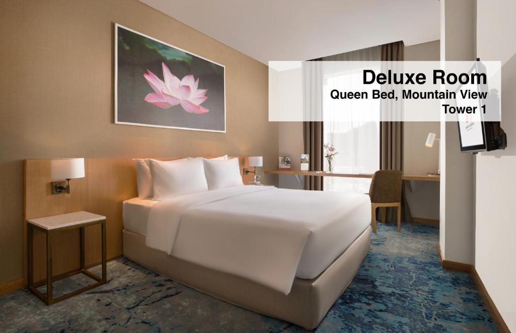 Postel nebo postele na pokoji v ubytování Swiss-Belinn Singkawang