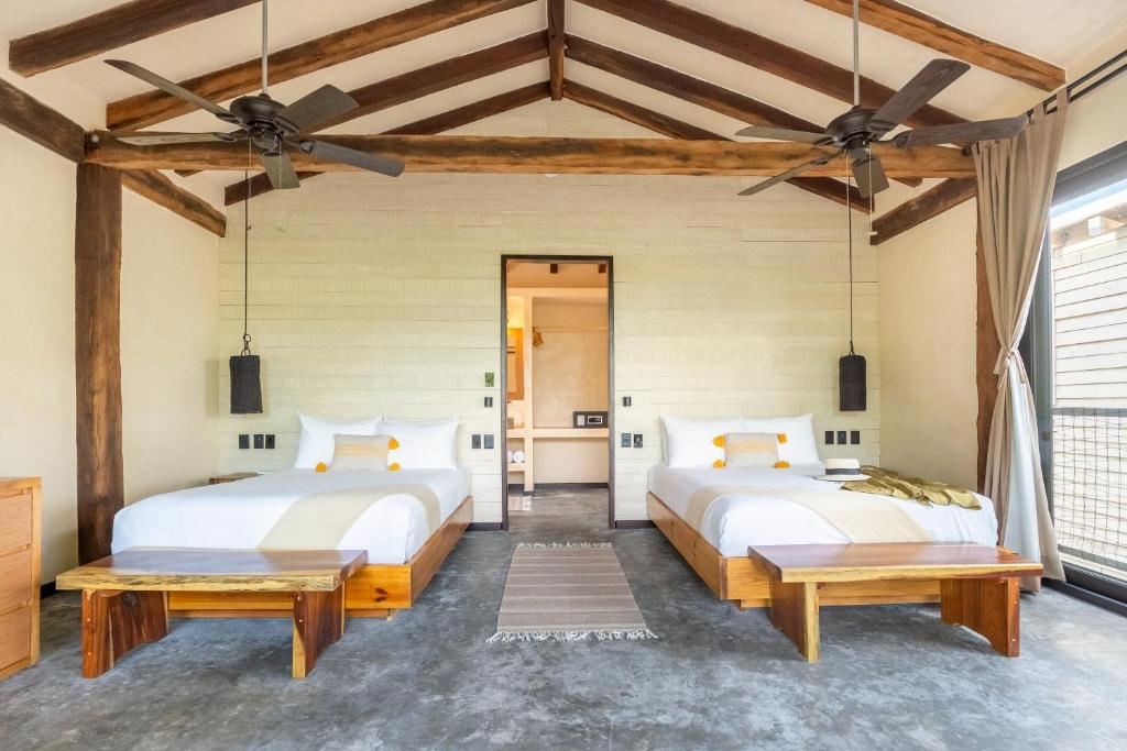 Кровать или кровати в номере Villa Pescadores Tulum-Beachfront hotel by Ahau Collection