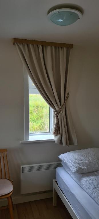 Postel nebo postele na pokoji v ubytování Guesthouse Stekkatún