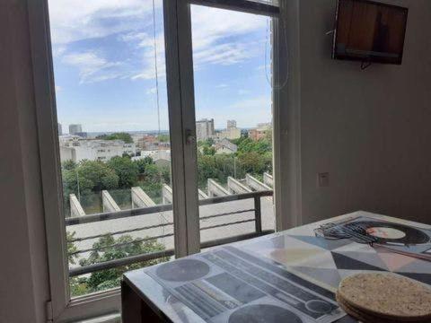 a room with a large window with a view of a balcony at Solo traveler's best stop near Paris in Bagnolet