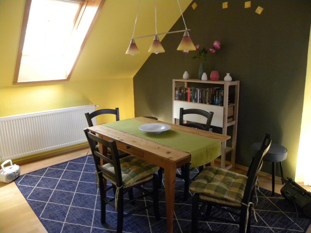 a dining room with a wooden table and chairs at Ferienwohnung an der Schorfheide in Schorfheide