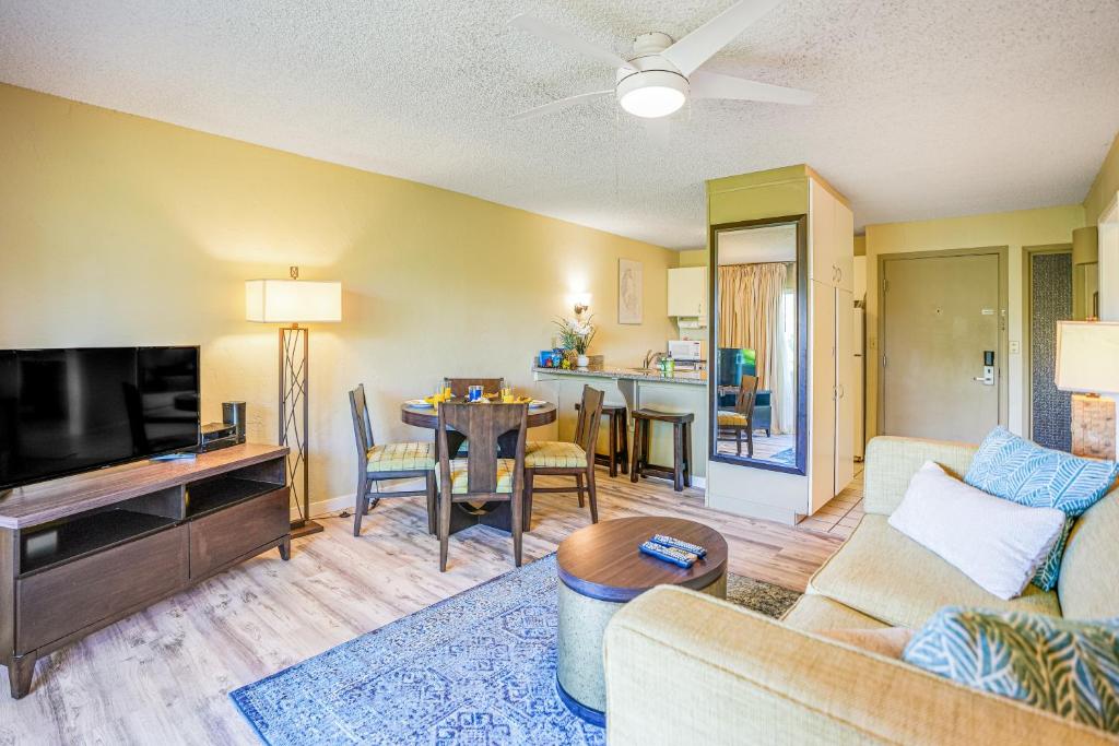 a living room with a couch and a tv at Plantation Hale D10 in Kapaa