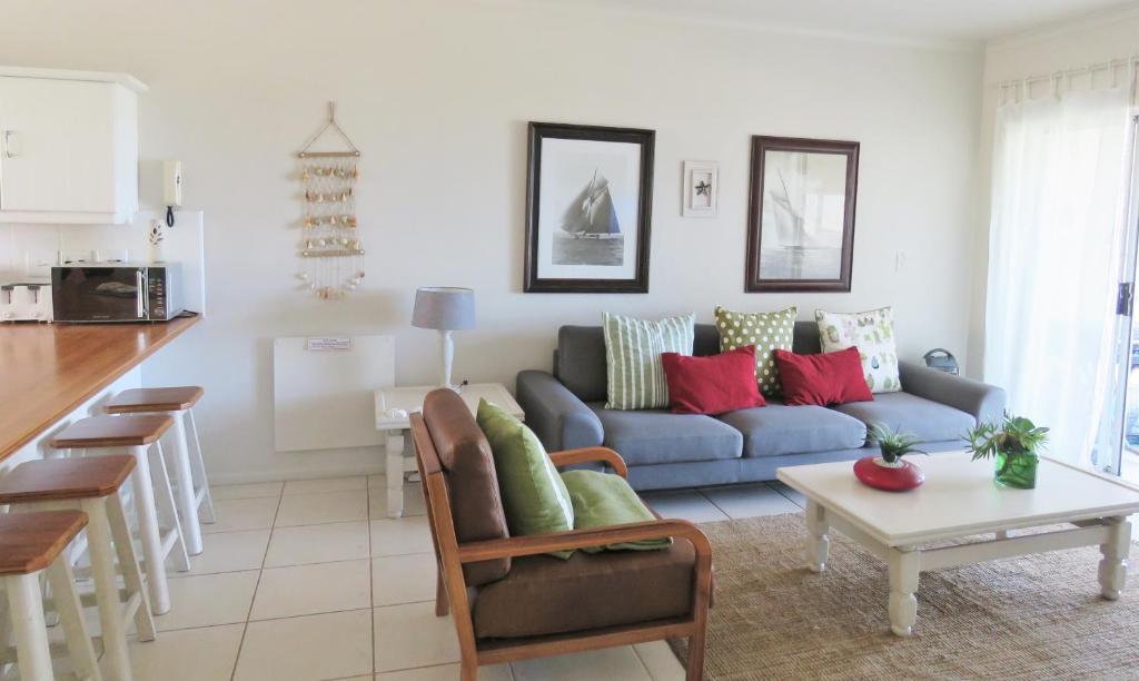 a living room with a couch and a table at The Potting Shed Self Catering in Hermanus