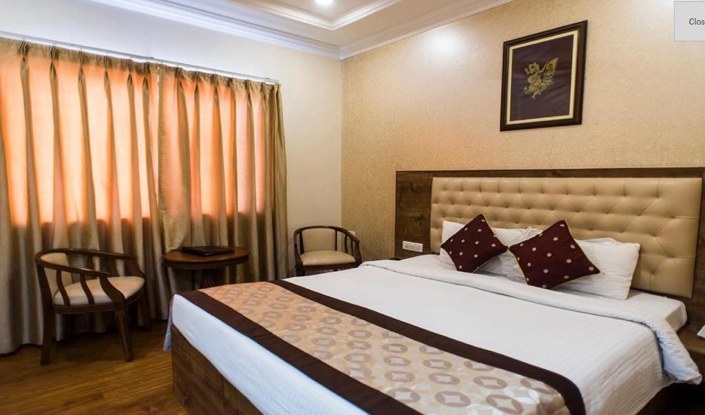 a bedroom with a large bed and a window at Wingston A TreeHouse Hotel, Mathura in Mathura