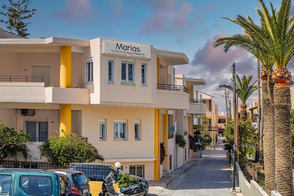 a building with a sign that reads motos at Marias Studios and Apartments in Plataniás