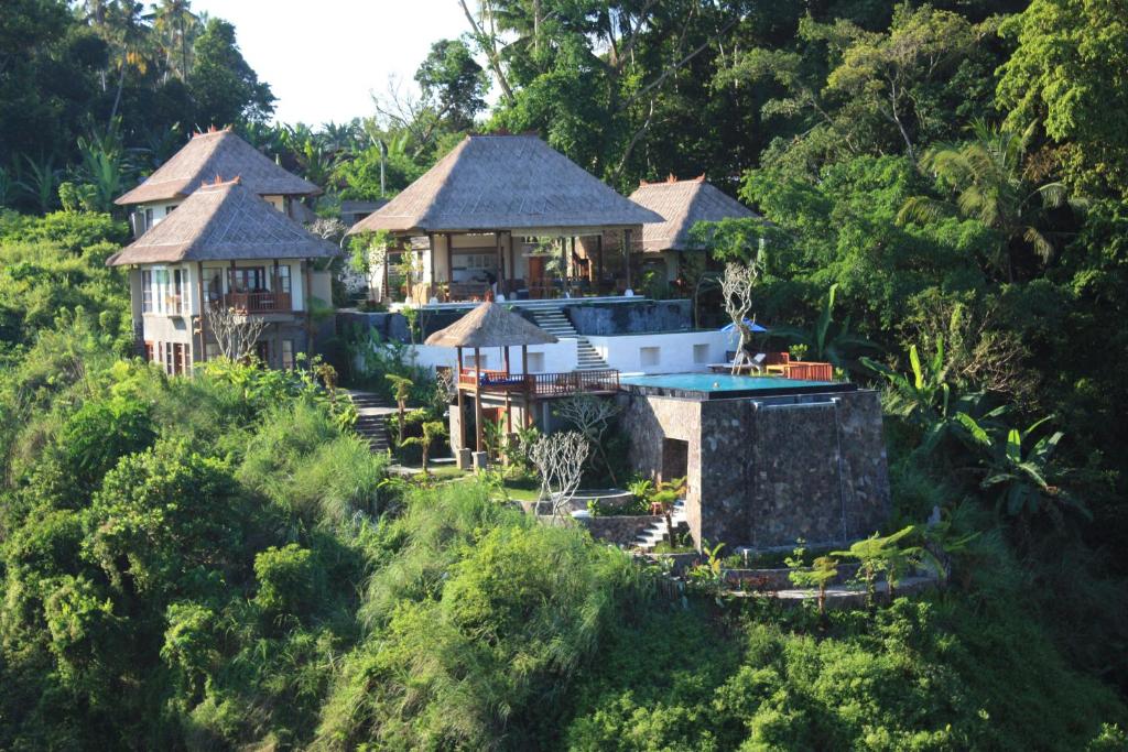 a house in the middle of a forest at Amori Villas in Ubud