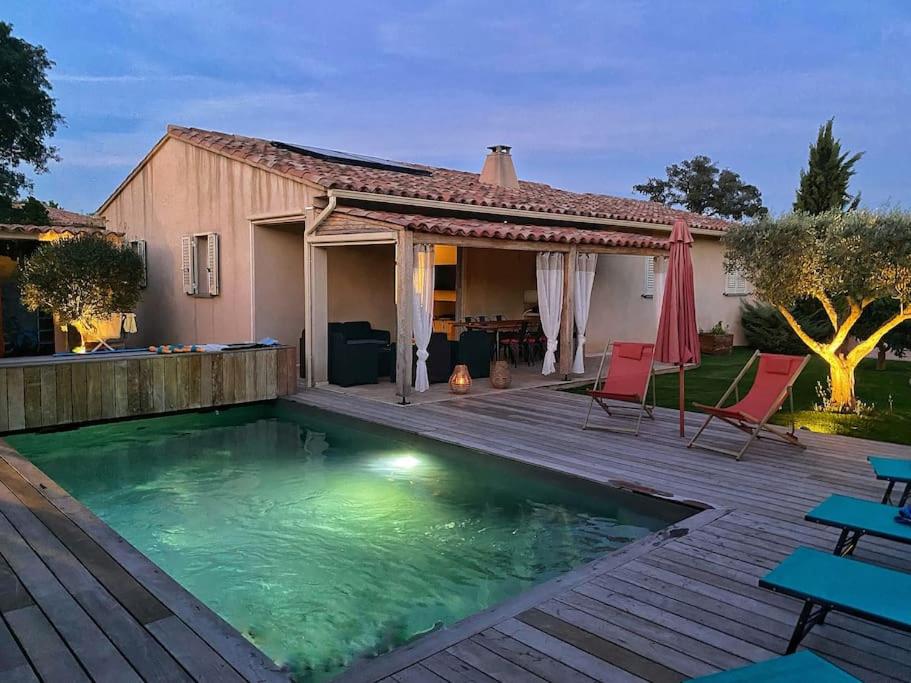 a swimming pool with a deck and a house at Villa avec piscine privée à Sainte Lucie in Sainte-Lucie de Porto-Vecchio