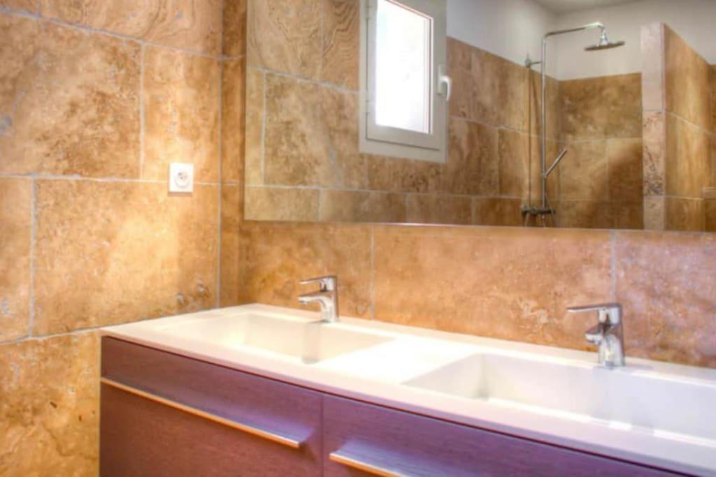 a bathroom with a sink and a mirror at Villa avec piscine privée à Sainte Lucie in Sainte-Lucie de Porto-Vecchio