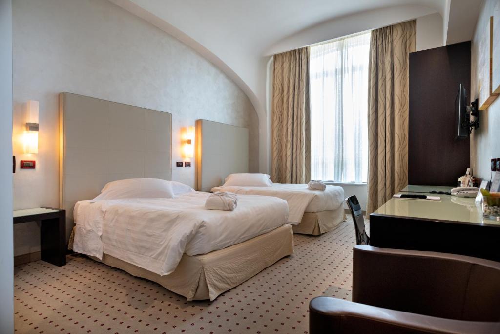 Posteľ alebo postele v izbe v ubytovaní Hotel La Cartiera