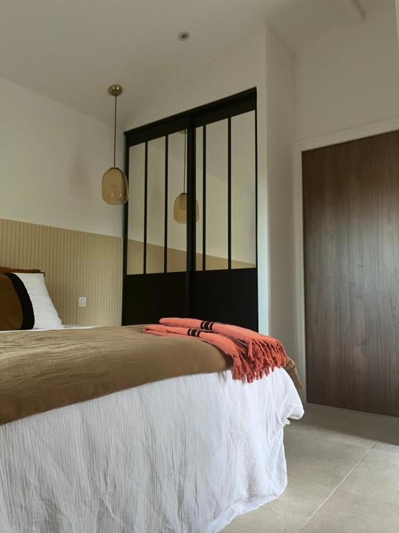 a bedroom with a large bed and a wooden cabinet at Suite La Farigoulette in Marseille