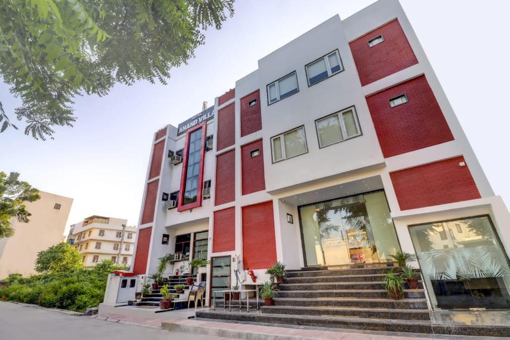 a building with stairs in front of it at Hotel Anand Villa in Agra