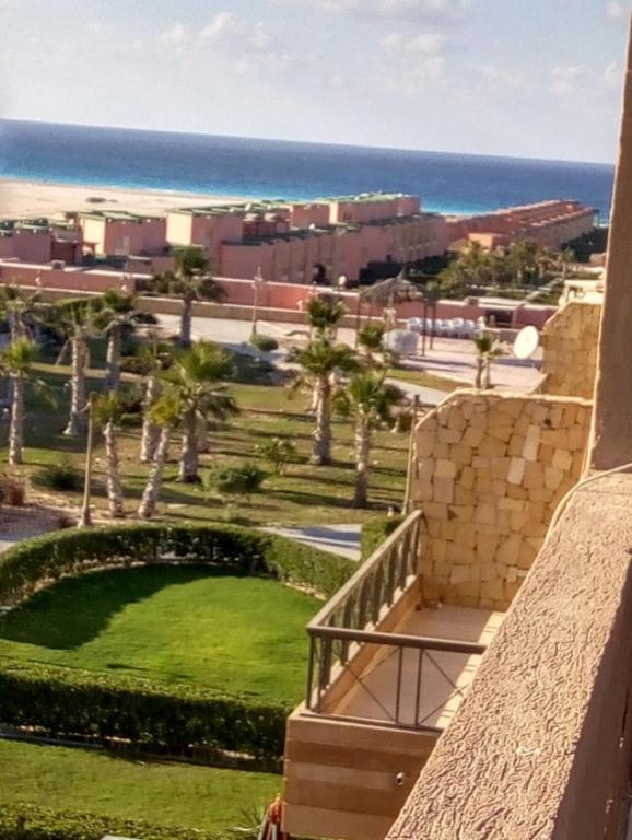 a balcony of a building with a view of the ocean at Chalet duplex in El Alamein