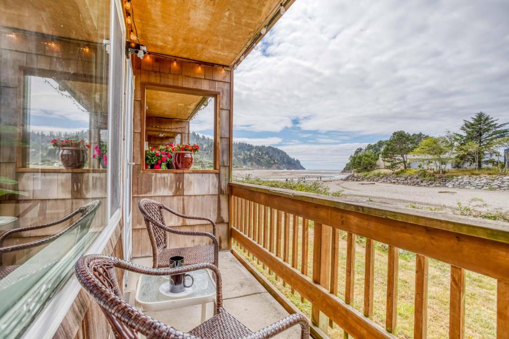a balcony with two chairs and a sink at The Bullpen 129 in Neskowin