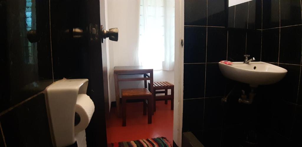 a bathroom with a sink and a toilet at Angel and Marie's Basic FANroom for 1 - 2 pax in Dalumpinas Oeste